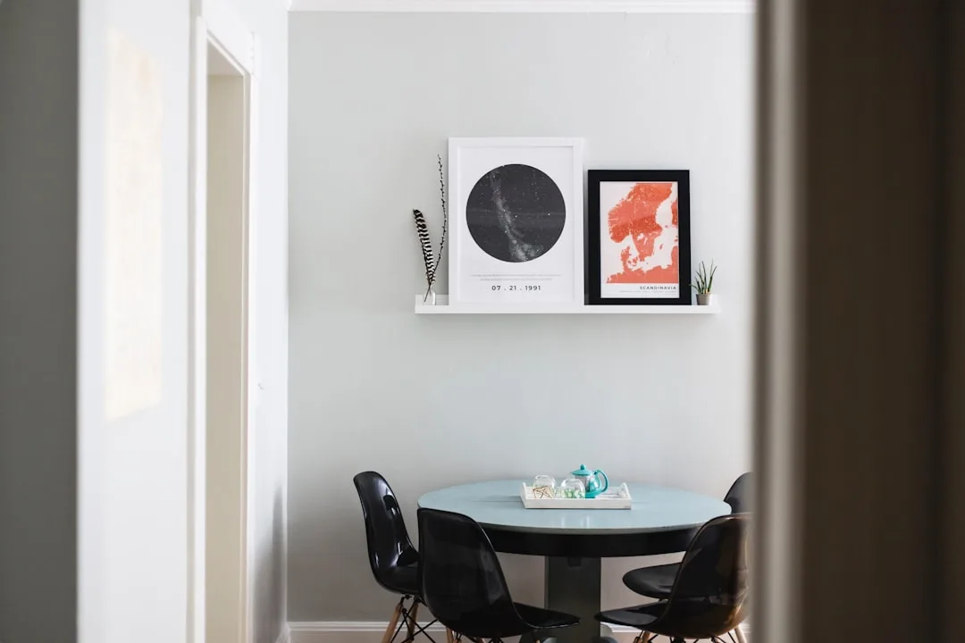 Small dining nook with round light blue table, bla