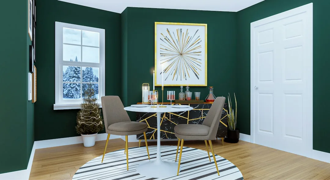 Green dining room with gold accents, striped rug, marble sideboard, and bold wall art showing color contrast in decor