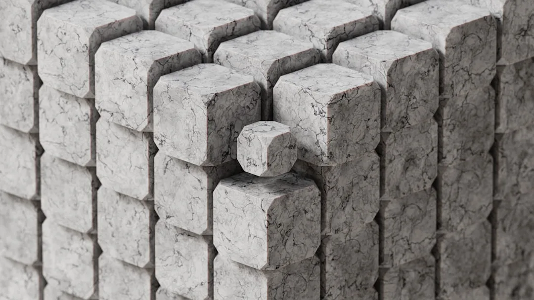 Marble-textured geometric stone blocks arranged in an industrial modular pattern showing raw material texture contrast