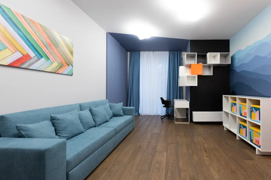 Narrow room with teal sofa, wall-mounted cube shelves and white storage unit maximizing space in elongated layout