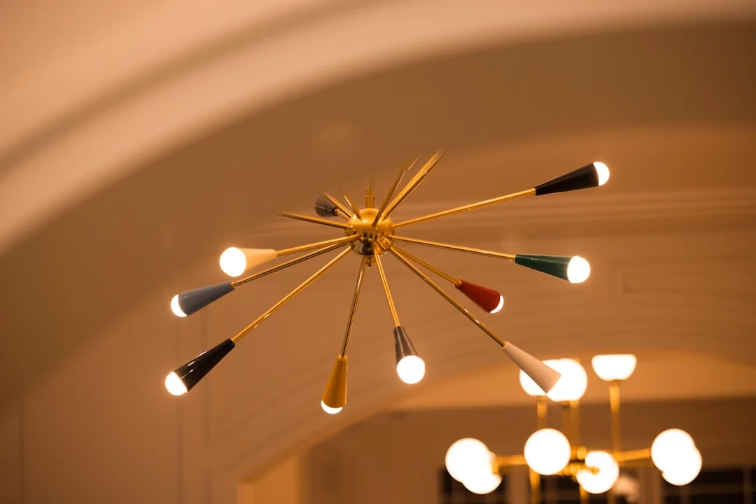 Mid-century modern Sputnik chandelier with colorful cone shades for layered bedroom lighting