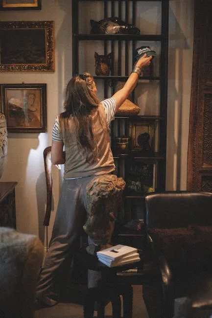 Woman browsing antique shelves filled with decorative objects and sculptures in a warmly lit vintage shop