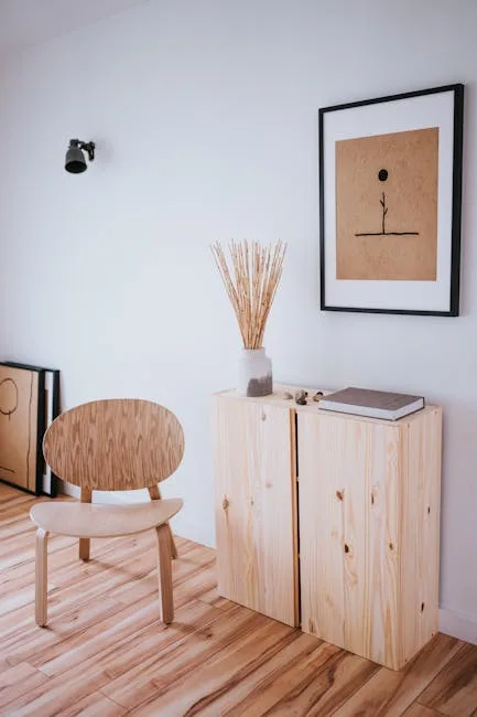 Japandi-style interior with light wood chair, pine storage boxes, dried pampas grass vase, and minimalist wall art