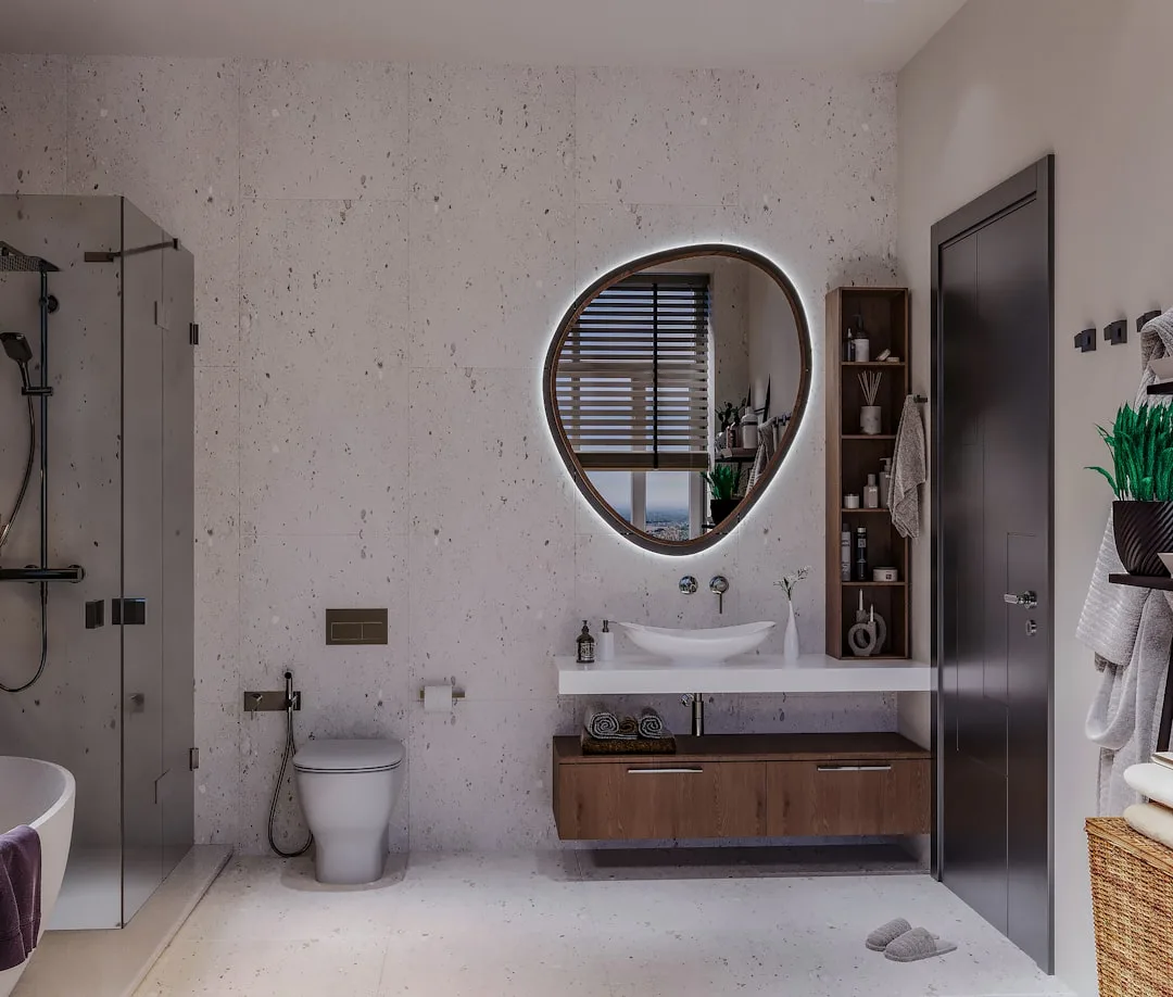 Modern bathroom renovation with floating wood vanity, backlit mirror, walk-in shower, and stone tile walls
