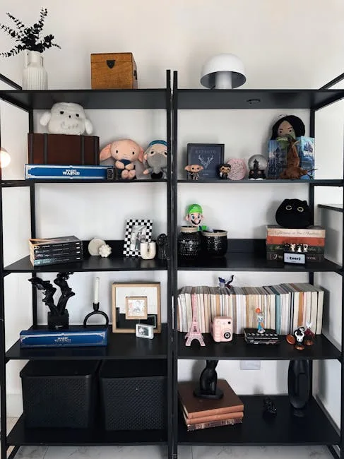 Black metal shelving unit styled with thrifted collectibles, books, plush toys, and decorative objects in a modern room