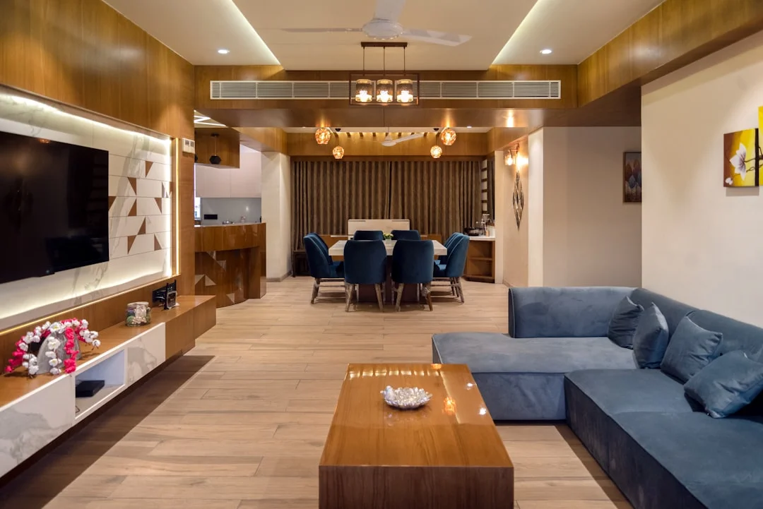 Open-plan living dining room layout with blue sectional sofa and dining table for medium to large ro