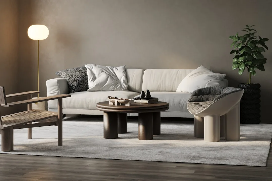 Japandi living room with cream sofa, round walnut coffee table, woven chair, floor lamp, and indoor plant on grey rug