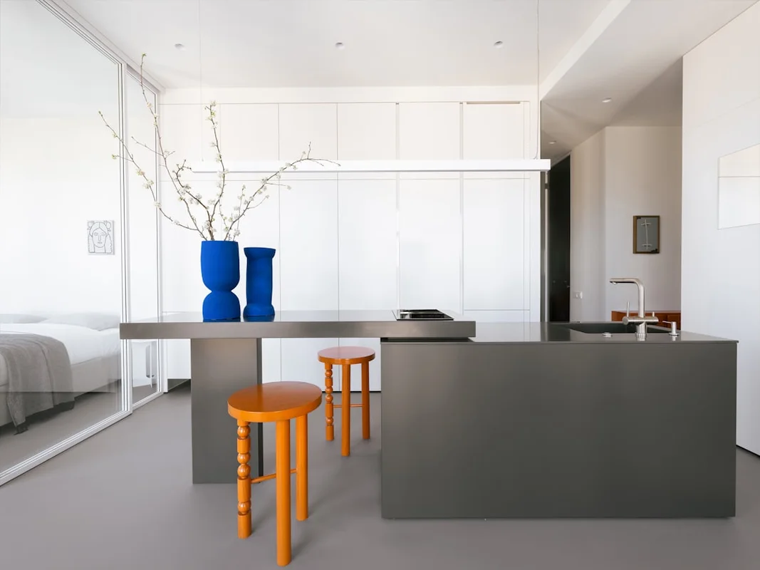 Japandi minimalist small apartment kitchen with gray island and colorful accents
