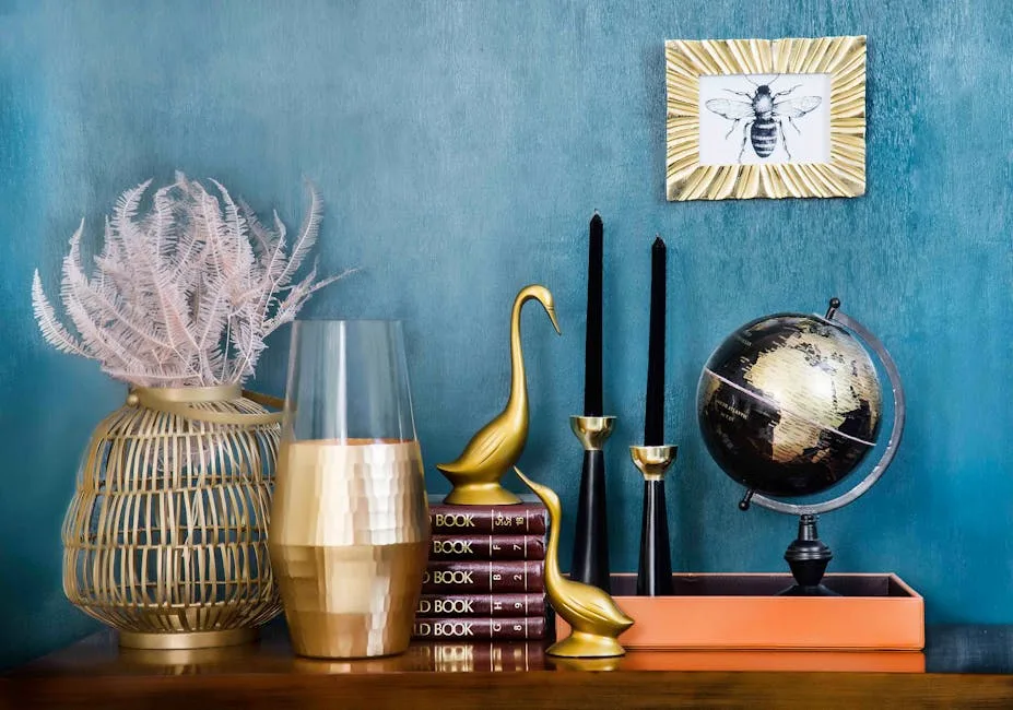 Thrift store home decor transformed with gold paint including swan figurines, globe, candle holders and wicker lantern o