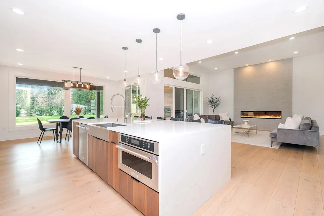 Open floor plan kitchen with large island connecting to living room, illustrating ventilation and smell challenges in op