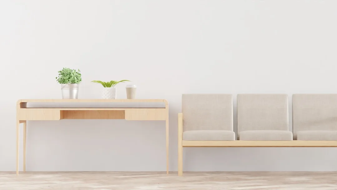Light wood console table beside a neutral linen sofa showing ideal height relationship between furniture pieces