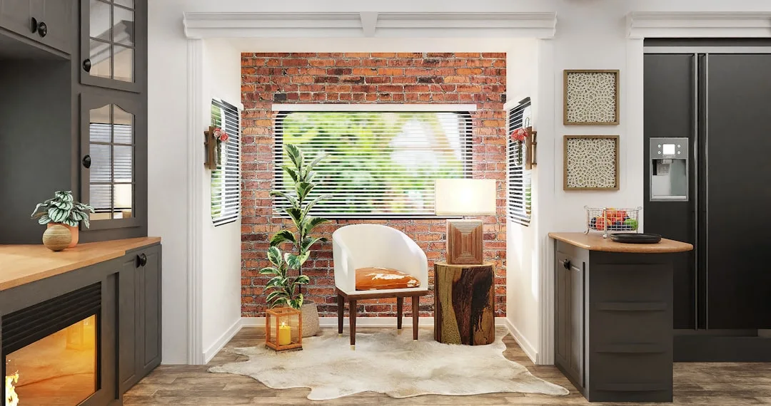 Industrial-style interior with exposed brick wall, white barrel chair, wood stump side table, and dark kitchen cabinetry