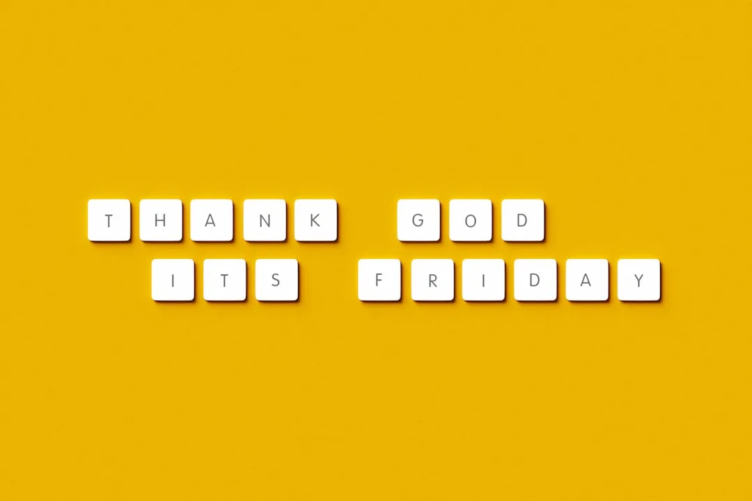 White letter tiles spelling Thank God It's Friday arranged on a bright yellow background