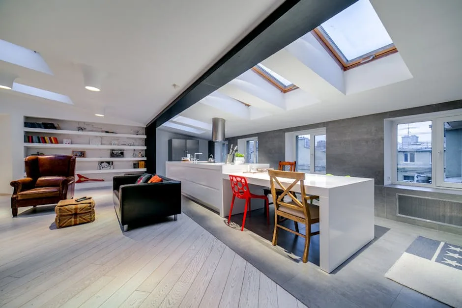 Converted attic living space with skylights, open kitchen island, wood floors, and modern interior design