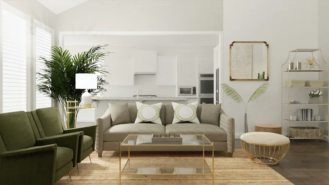 Modern living room with beige sofa, gold coffee table, green velvet armchair, and white kitchen open concept layout