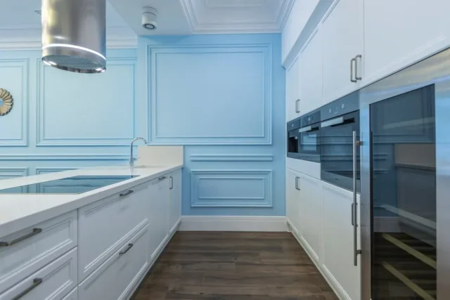 Modern kitchen with powder blue walls, white shake