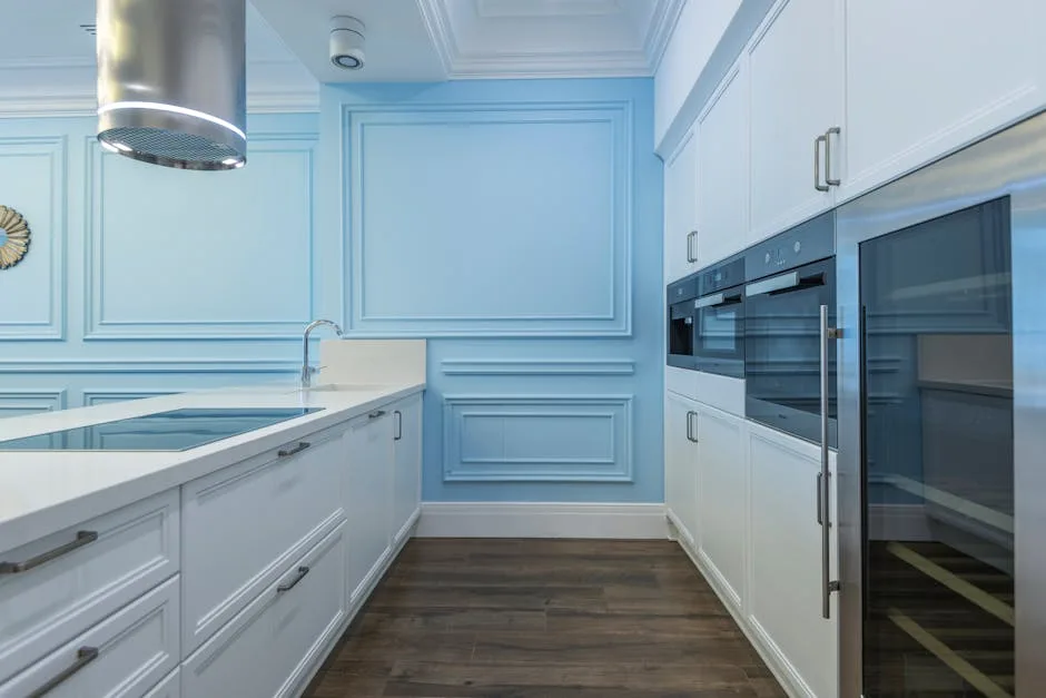 Modern kitchen with powder blue walls, white shake