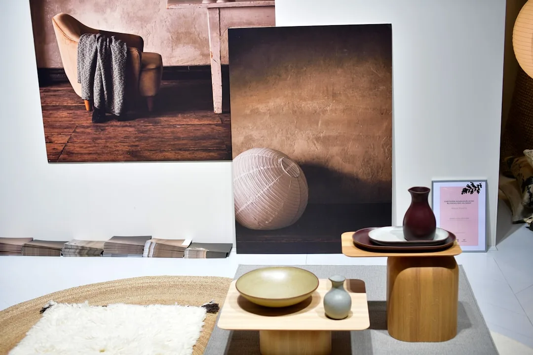 Japandi-style display with wooden side tables, cer