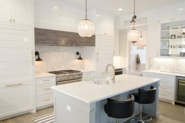 White farmhouse kitchen with center island, marble