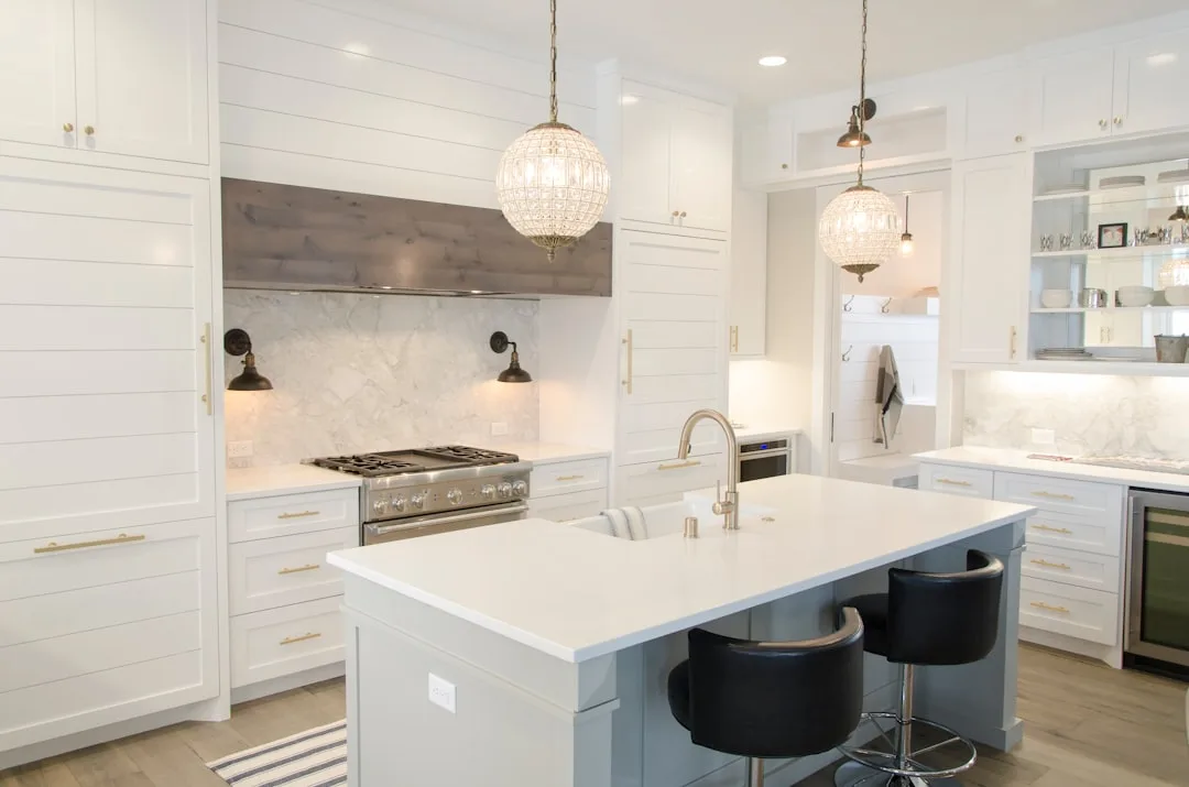 White farmhouse kitchen with center island, marble