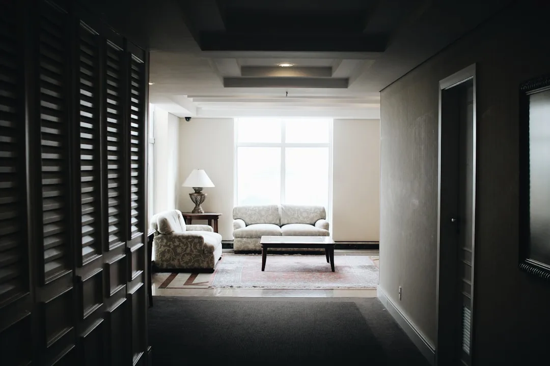 Long narrow hallway leading into a living room wit