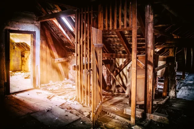 Abandoned attic interior with exposed wooden roof