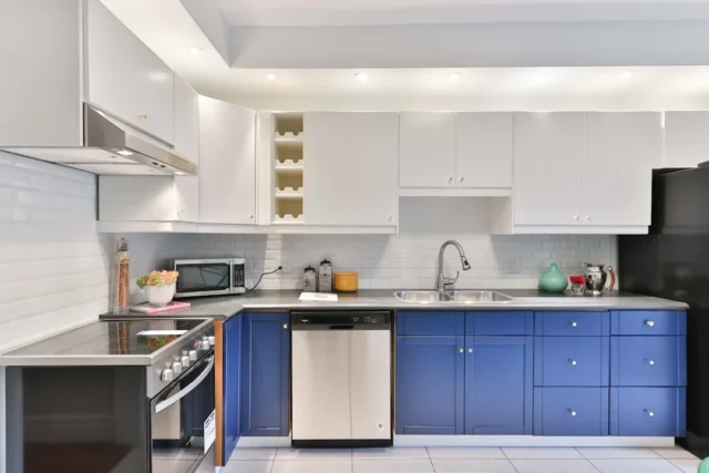 Modern kitchen with two-tone blue lower cabinets a