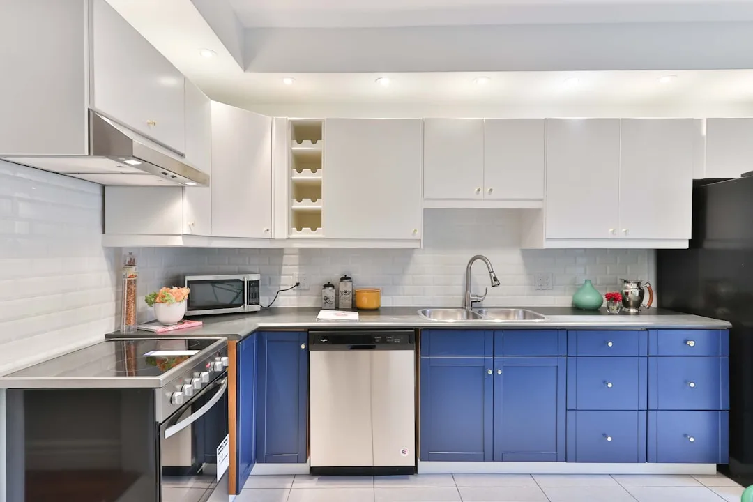 Modern kitchen with two-tone blue lower cabinets a