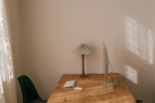 Minimalist home office desk with iMac, keyboard, m
