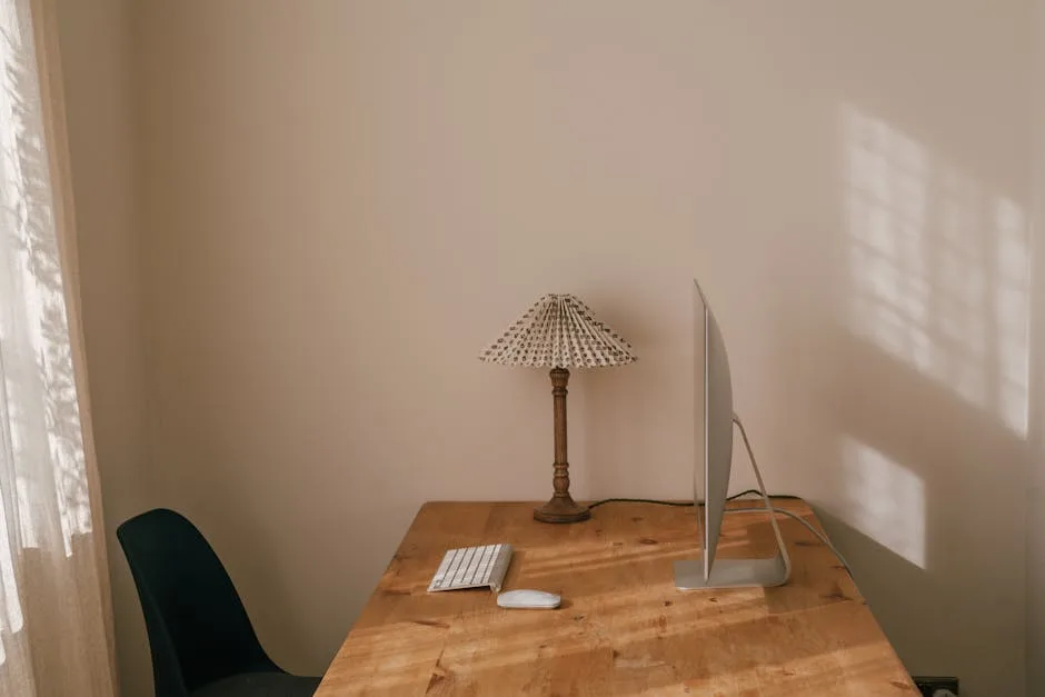 Minimalist home office desk with iMac, keyboard, m