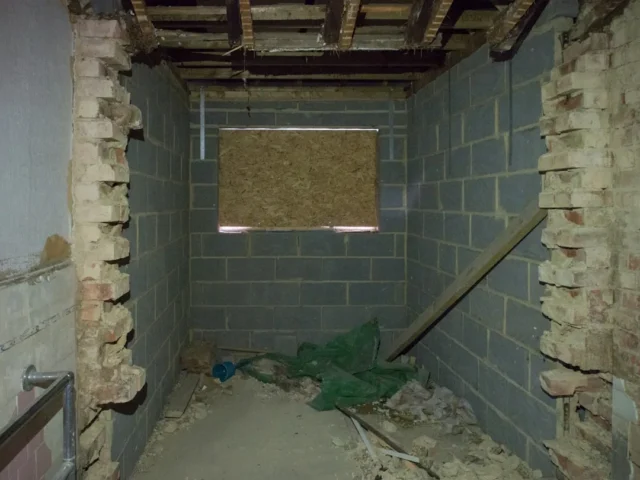 Unfinished basement with exposed cinder block wall