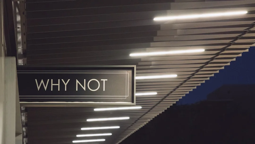 Why Not sign under architectural ceiling with line