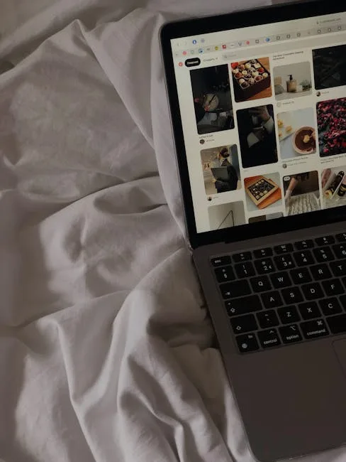 MacBook laptop on white bed sheets displaying Pint