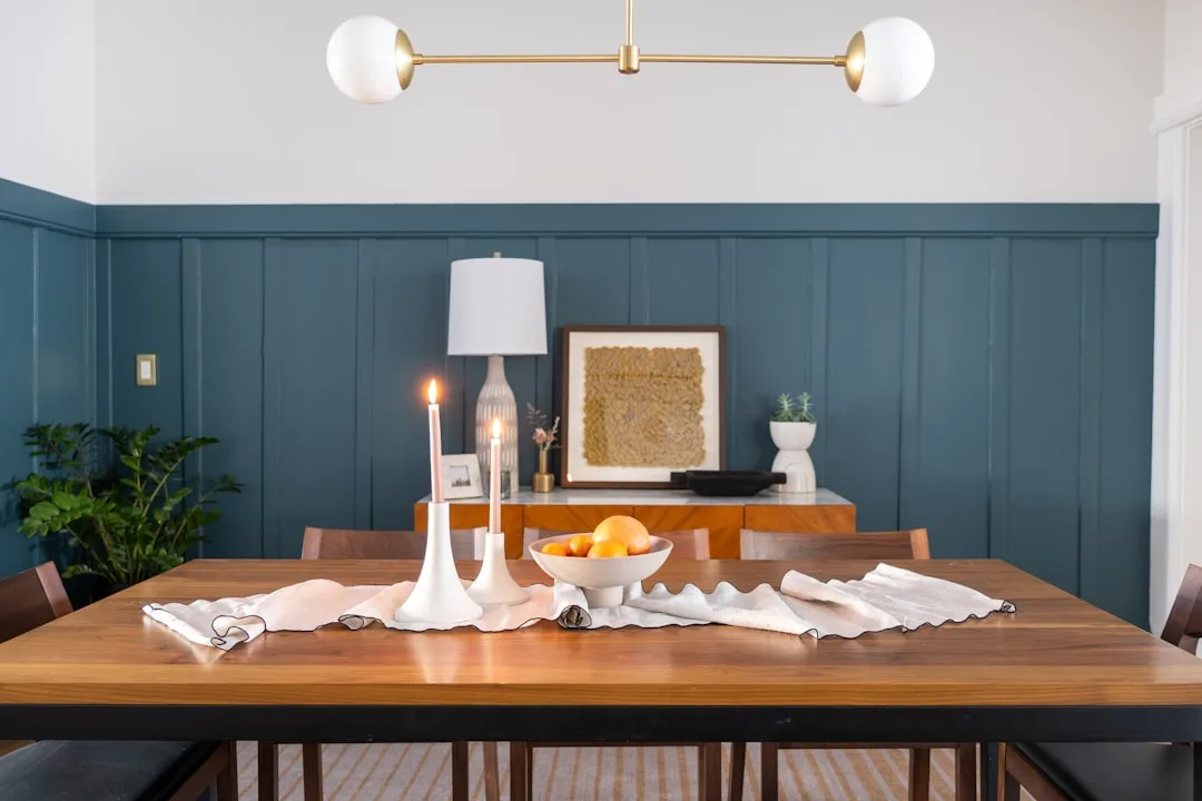 Styled mid-century modern dining room with teal wa