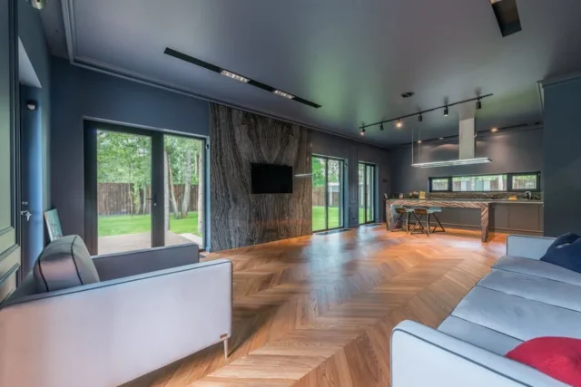 Modern open-plan living room with herringbone hard