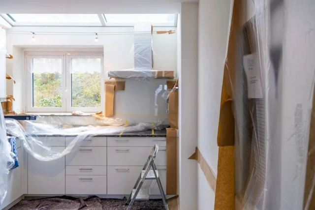 Kitchen renovation in progress with white cabinets