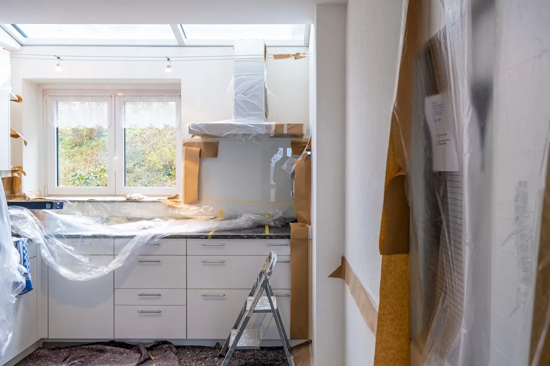 Kitchen renovation in progress with white cabinets