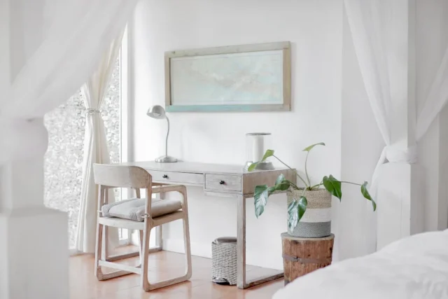 Minimalist bedroom workspace with whitewashed wood