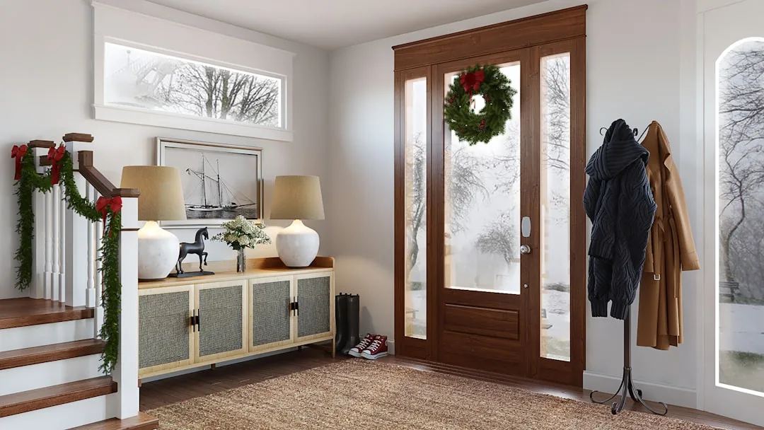 Entryway coat rack with winter coats and scarves beside front door with Christmas wreath and boots on floor