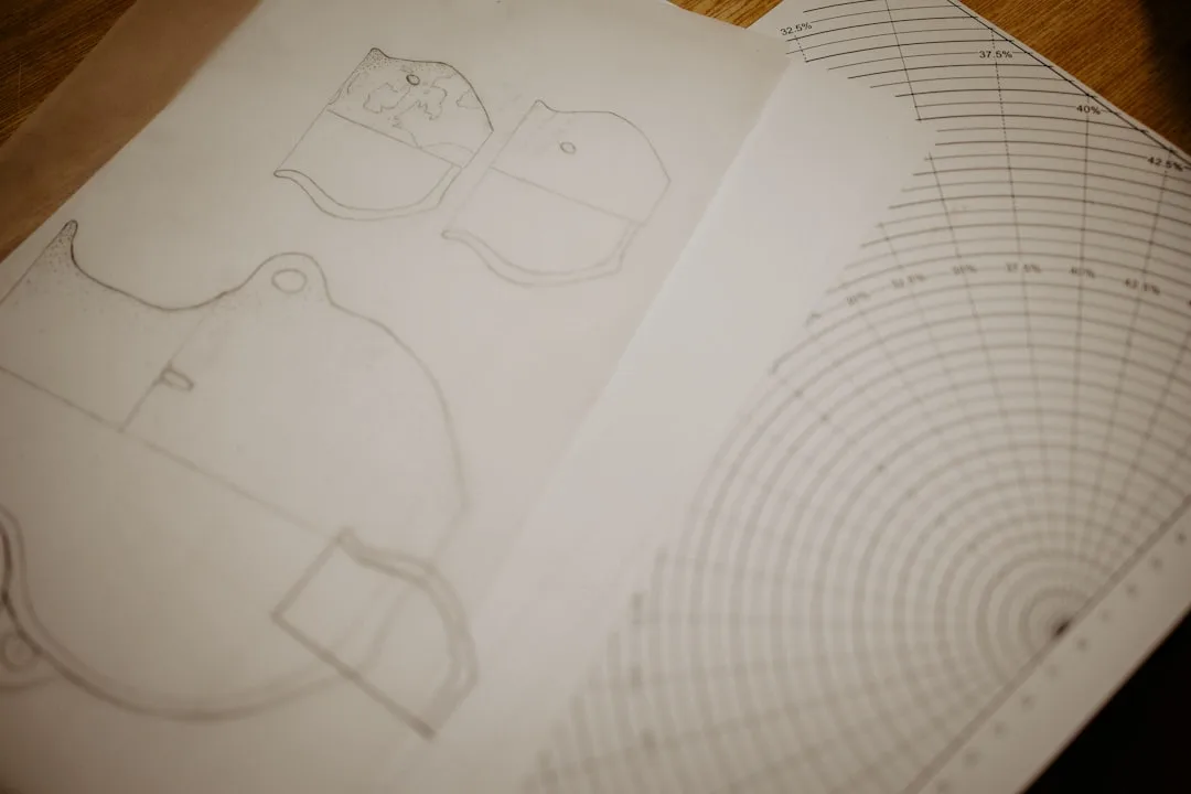 Hand-drawn paper layout sketches for furniture arrangement planning before moving pieces in a small bedroom
