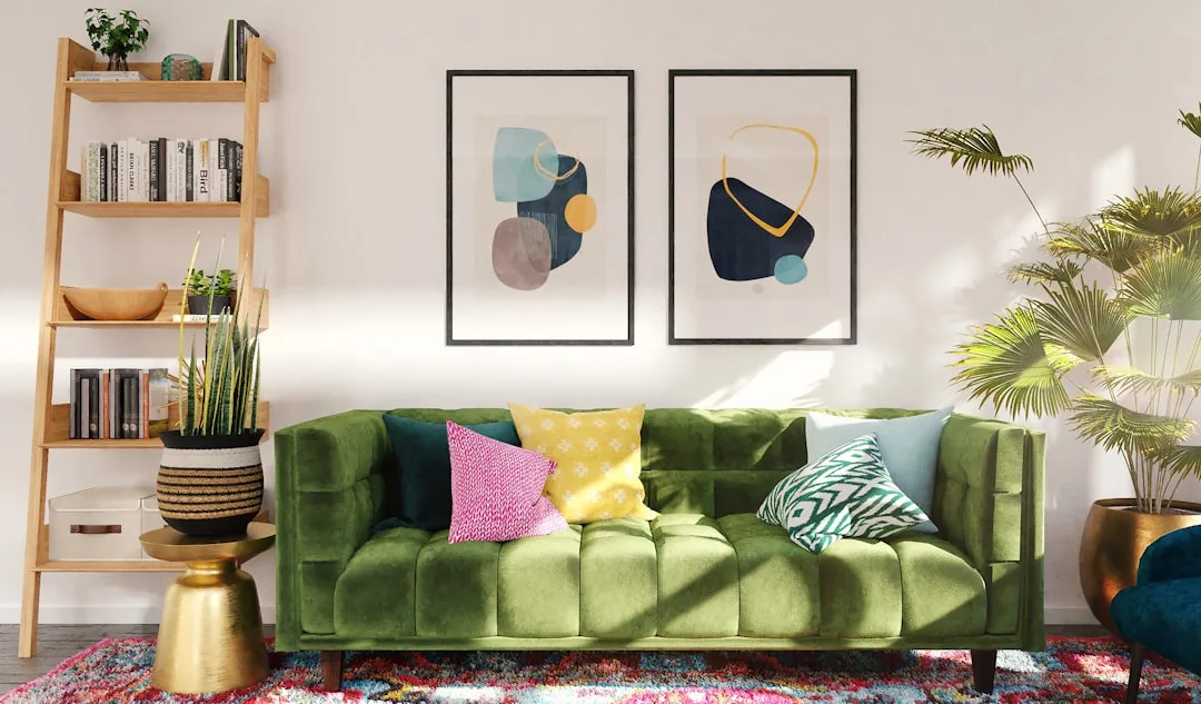 Green velvet sofa with colorful throw pillows in pink, yellow, and teal in a modern living room