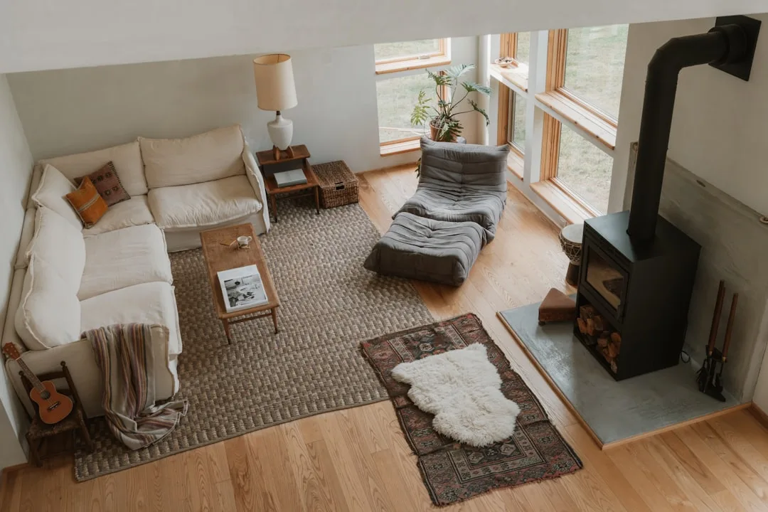 Overhead view of living room with white sectional sofa and rectangular jute rug anchoring the seating area