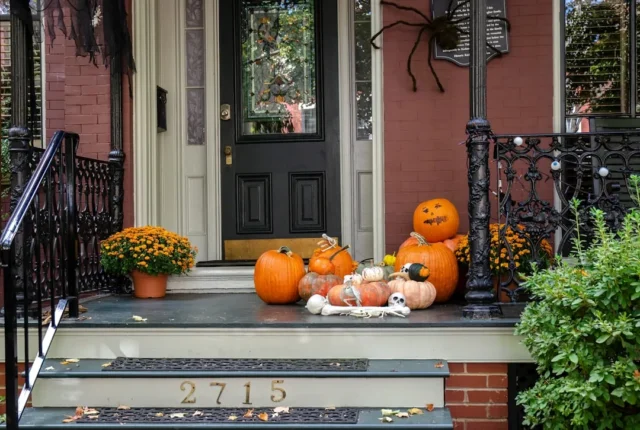 Halloween fall front porch with pumpkins, skeleton