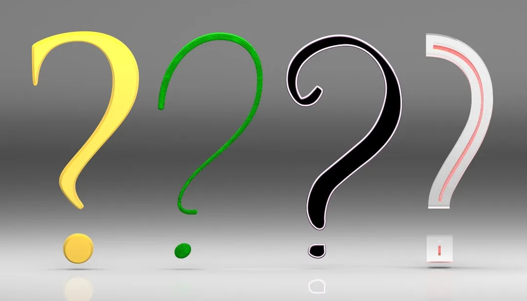 Four colorful 3D question marks in yellow, green, black, and white representing frequently asked questions