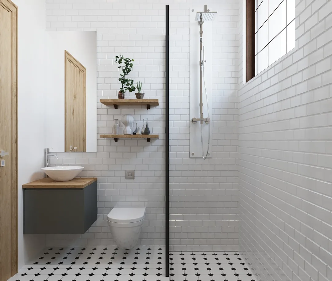 White subway tile bathroom with visible grout lines, black and white mosaic floor, walk-in shower and floating vanity