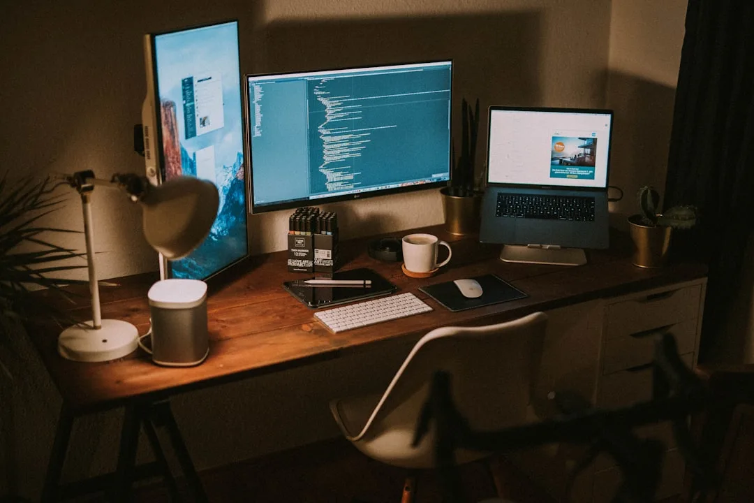 Wooden desk setup with two monitors and laptop showing how much desk space is needed for dual screen configuration
