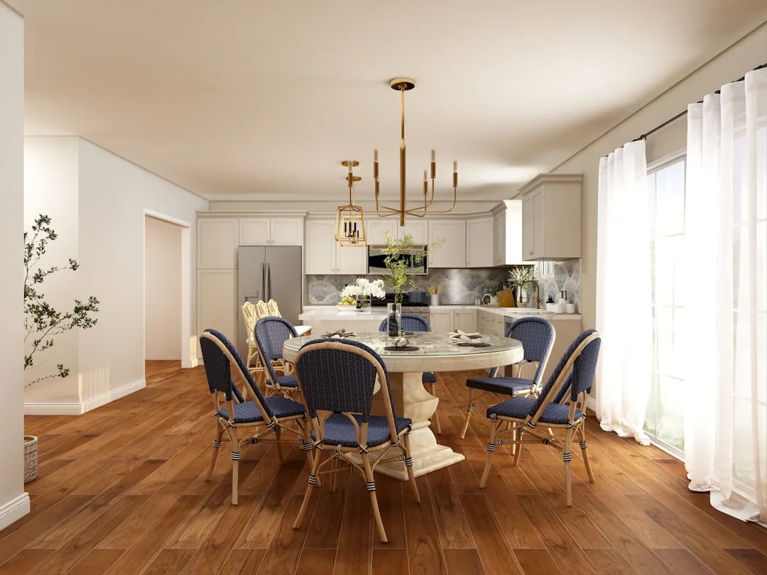 Open-concept kitchen dining room with round marble table, blue bistro chairs, hardwood floors and gold chandelier