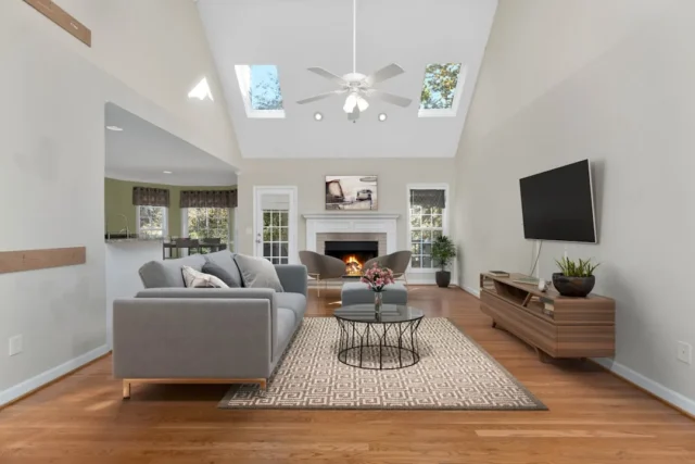 Neutral living room with gray sofa, warm wood floo