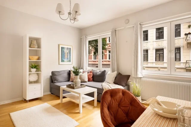 Bright living room with greige walls, gray sofa, w