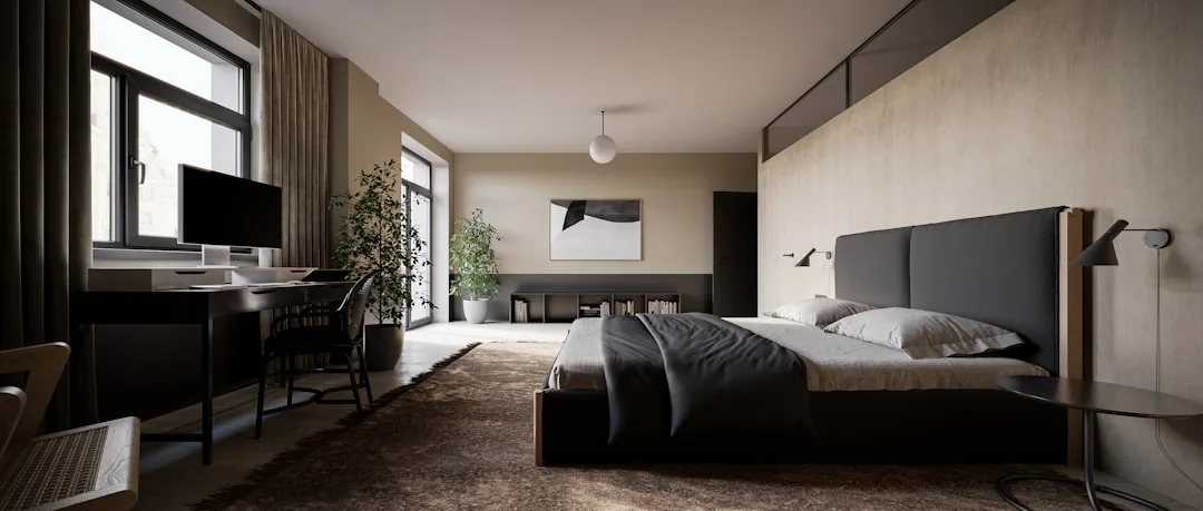 Modern bedroom with coordinated dark furniture, upholstered headboard, desk area and neutral tones showing intentional d